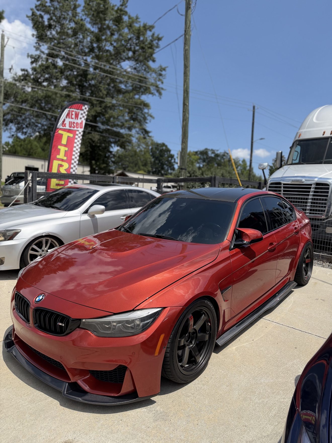 Red BMW M3 sedan at Auto Haus Solutions in Cumming, GA